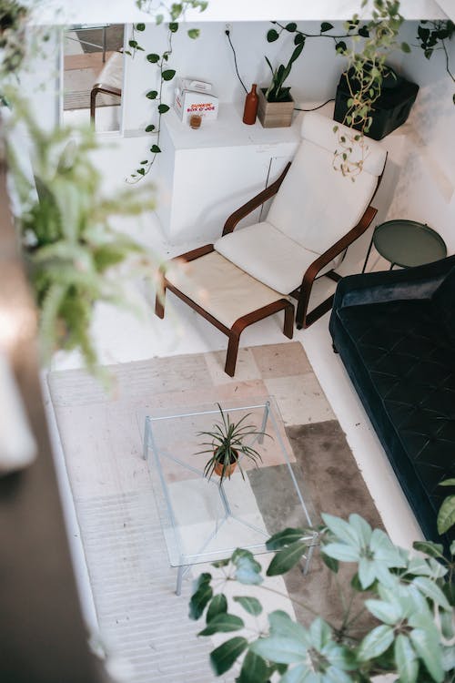 Stylish living room interior with furniture on tiled floor