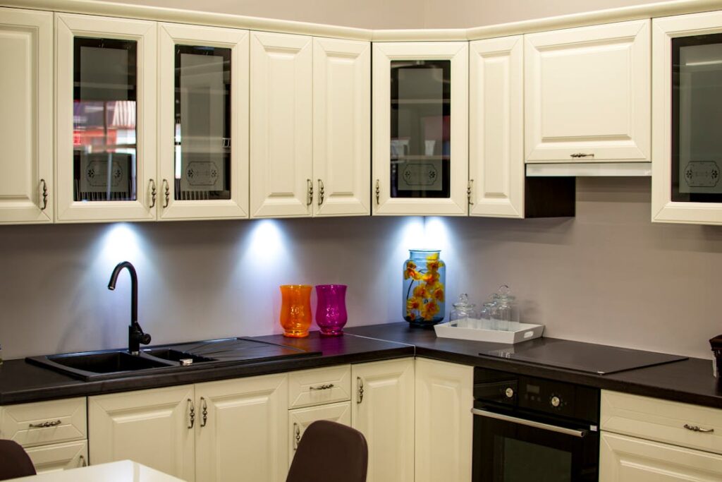 An image of a kitchen with a black and off-white theme