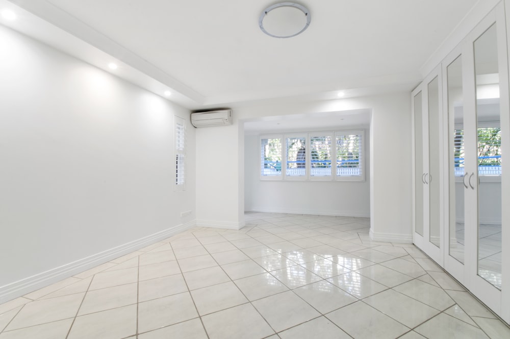 An empty room with white tiles