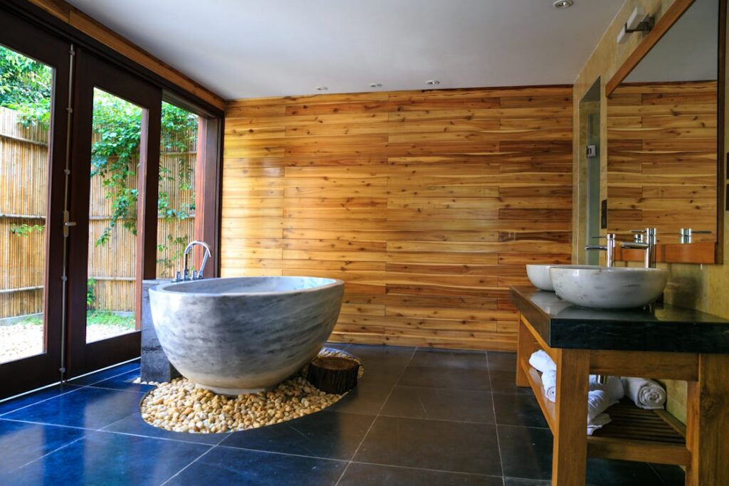 An image of a round white and gray ceramic bathtub inside a bathroom